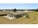 Exterior view showing backyard with a single car garage and a white picket fence at 5201 Dorman Rd, Lakeland, FL 33813