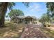 Charming single-story home with a covered front porch and yellow front door at 5201 Dorman Rd, Lakeland, FL 33813