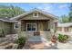 Cozy front porch featuring a yellow door, tiled floor, and a comfortable space for relaxation at 5201 Dorman Rd, Lakeland, FL 33813