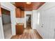 Hallway with wood flooring, wooden cabinets, and a window, combining practicality with a classic design at 5201 Dorman Rd, Lakeland, FL 33813