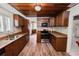 Traditional kitchen featuring wooden cabinets, modern appliances, and wood-look tile flooring at 5201 Dorman Rd, Lakeland, FL 33813