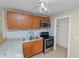 Kitchen boasts stainless steel appliances, wooden cabinets, tile backsplash, and a ceiling fan at 5201 Dorman Rd, Lakeland, FL 33813