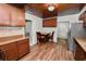 Eat-in kitchen featuring wooden cabinets, table with two chairs, and wood-look tile flooring at 5201 Dorman Rd, Lakeland, FL 33813