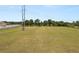 Large, grassy field offering ample space and potential, with utility poles along the perimeter at 5201 Dorman Rd, Lakeland, FL 33813