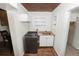 Laundry room with modern washer and dryer, sink, shelving and tile flooring at 5201 Dorman Rd, Lakeland, FL 33813