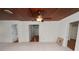 Bright, spacious living room with wood ceiling, ceiling fans, and neutral tile flooring at 5201 Dorman Rd, Lakeland, FL 33813
