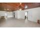 Bright, spacious living room with wood ceiling, ceiling fans, and neutral tile flooring at 5201 Dorman Rd, Lakeland, FL 33813