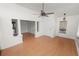 Living room with a ceiling fan, wood flooring, and a doorway with pillars that adds character to the space at 5201 Dorman Rd, Lakeland, FL 33813