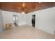 Bright, spacious living room with wood ceiling, ceiling fan, and neutral tile flooring at 5201 Dorman Rd, Lakeland, FL 33813