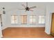 Large living room with wood flooring and natural light streaming through the beautiful row of windows at 5201 Dorman Rd, Lakeland, FL 33813
