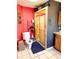 Bathroom with a toilet, walk-in shower, and a red wall adding vibrant color at 5218 Parkland Ct, Lakeland, FL 33811