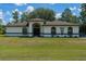 Charming single-story home boasts a well-manicured front lawn, arched entryway, and neutral-toned exterior at 5218 Parkland Ct, Lakeland, FL 33811