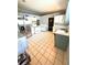 Practical kitchen featuring stainless steel refrigerator, white cabinets and a large tile floor at 5218 Parkland Ct, Lakeland, FL 33811