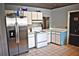 Functional kitchen equipped with stainless steel refrigerator, white appliances and ample counter space at 5218 Parkland Ct, Lakeland, FL 33811