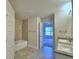 The Primary bathroom includes a dual sink vanity, granite countertops and tile flooring at 535 Tanaro Ln, Haines City, FL 33844