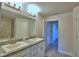 The bathroom features granite countertops, double sinks, modern faucets, and tiled shower at 535 Tanaro Ln, Haines City, FL 33844