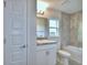 Clean bathroom featuring a white sink, vanity, toilet and a tiled tub and shower at 535 Tanaro Ln, Haines City, FL 33844