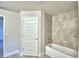 This bathroom features a tub, a tiled shower and tile flooring at 535 Tanaro Ln, Haines City, FL 33844