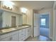 Double vanity bathroom with granite countertops, and doorway view of another room at 535 Tanaro Ln, Haines City, FL 33844