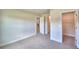 Spacious bedroom featuring carpeted floor, neutral colored paint and doors leading to en-suite bath and walk-in closet at 535 Tanaro Ln, Haines City, FL 33844