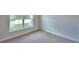 Bright bedroom featuring neutral carpet, window with natural light, and clean, painted walls at 535 Tanaro Ln, Haines City, FL 33844