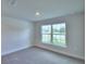 A well-lit bedroom with new carpet, fresh paint and a window at 535 Tanaro Ln, Haines City, FL 33844