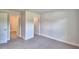 A bedroom with neutral walls and carpeting featuring doors leading to a bathroom and closet at 535 Tanaro Ln, Haines City, FL 33844
