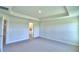 Bedroom with carpet flooring, neutral walls, and trim features an ensuite bathroom, door frames and recessed ceiling at 535 Tanaro Ln, Haines City, FL 33844