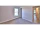 Carpeted bedroom with window and view to en-suite bathroom at 535 Tanaro Ln, Haines City, FL 33844