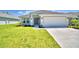 Charming single-story home with a well-manicured lawn and an attached two-car garage at 535 Tanaro Ln, Haines City, FL 33844