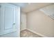 Hallway features tile flooring, white walls and door frames and an additional coat rack with wire shelving at 535 Tanaro Ln, Haines City, FL 33844