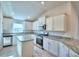 Well-lit kitchen featuring granite countertops, an island, stainless steel appliances and ample storage space at 535 Tanaro Ln, Haines City, FL 33844
