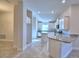 Bright kitchen with white cabinetry, granite countertops, and stainless steel appliances at 535 Tanaro Ln, Haines City, FL 33844
