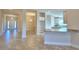 Open concept kitchen with white cabinets, a granite breakfast bar and stainless steel appliances at 535 Tanaro Ln, Haines City, FL 33844