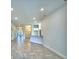 The living area features tile floors, recessed lighting, and an open layout towards the dining and kitchen areas at 535 Tanaro Ln, Haines City, FL 33844
