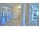 Open concept living space with tile floors, columns, a chandelier, and a view to the kitchen at 535 Tanaro Ln, Haines City, FL 33844