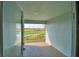 View from covered patio showing pond, wetlands and bright blue sky in the distance at 535 Tanaro Ln, Haines City, FL 33844