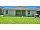 Backyard with a covered patio, green grass, and well maintained AC unit at 539 Tanaro Ln, Haines City, FL 33844