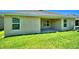 Backyard with a covered patio, green grass, and the exterior of the home at 539 Tanaro Ln, Haines City, FL 33844