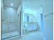 Beautiful bathroom featuring a tiled shower, dual sinks, and granite countertop at 539 Tanaro Ln, Haines City, FL 33844