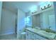 Bathroom with double sinks and a walk in shower at 539 Tanaro Ln, Haines City, FL 33844