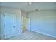 Light, airy bedroom with neutral carpet and two closet doors at 539 Tanaro Ln, Haines City, FL 33844