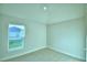 Well-lit bedroom with neutral carpet, a large window, and painted walls at 539 Tanaro Ln, Haines City, FL 33844