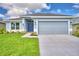 Charming single-story home featuring a well-manicured lawn and a two-car garage at 539 Tanaro Ln, Haines City, FL 33844