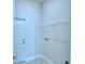 Functional laundry room featuring tile flooring and a wire shelf at 539 Tanaro Ln, Haines City, FL 33844