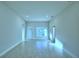 Spacious living room with light wood-look flooring and neutral paint at 539 Tanaro Ln, Haines City, FL 33844