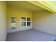 Covered patio with concrete floors and a doorway and window looking into the home at 539 Tanaro Ln, Haines City, FL 33844