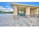 Outdoor pavilion with stone columns, ceiling fans, and seating area overlooking the community pool at 539 Tanaro Ln, Haines City, FL 33844
