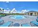 Inviting community pool with lounge chairs and a nearby pavilion offering shaded seating at 539 Tanaro Ln, Haines City, FL 33844