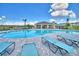 Relaxing poolside view with lounge chairs and a shaded pavilion for ultimate comfort and leisure at 539 Tanaro Ln, Haines City, FL 33844